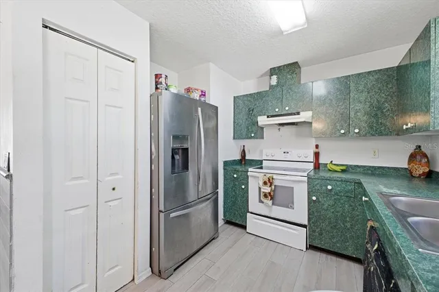 a kitchen with a refrigerator and a sink