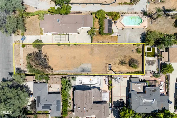 an aerial view of multiple houses with outdoor space