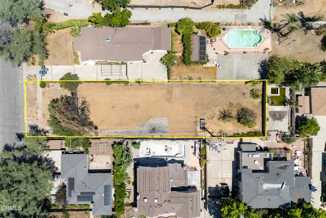 an aerial view of multiple houses with outdoor space
