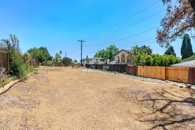 a backyard of a house with lots of green space and trees
