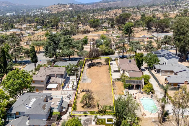 an aerial view of residential houses with outdoor space
