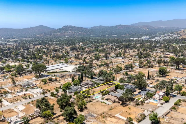 an aerial view of residential house and covered with snow