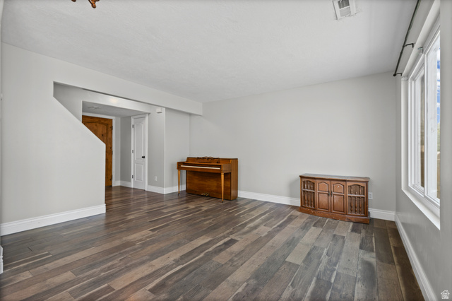 1346 Archmore Drive Springville, UT 84663 - Photo 6 of 32 Spacious room featuring wide plank wood-finish flooring, white baseboards, and light gray walls