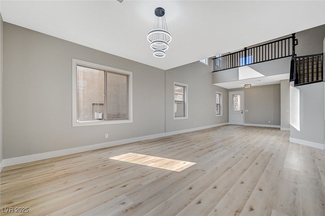 153 Tall Ruff Drive Las Vegas, NV 89148 - Photo 11 of 59 Unfurnished living room with baseboards, light woo