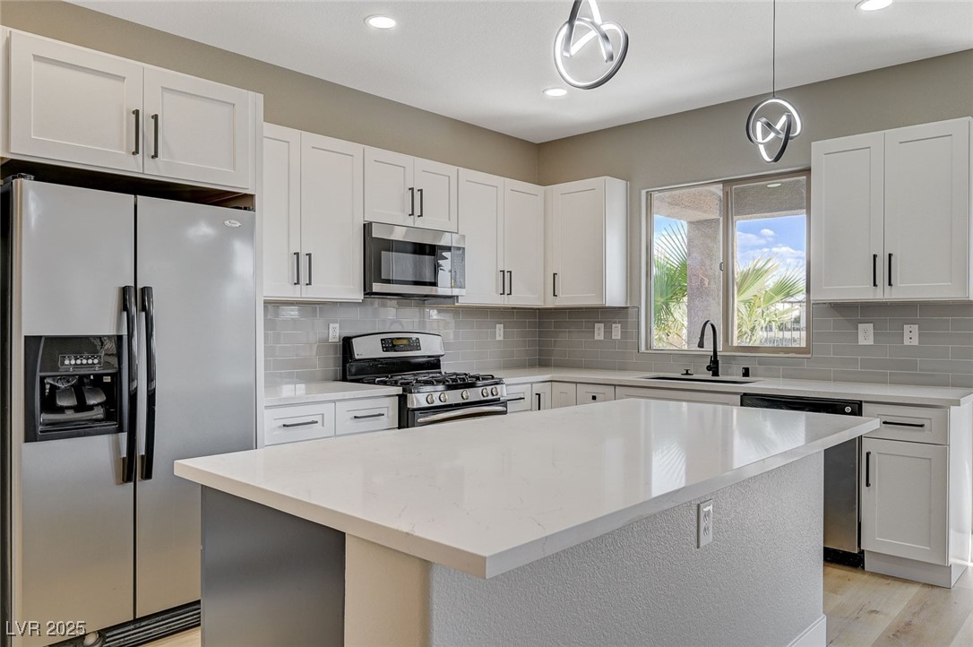 153 Tall Ruff Drive Las Vegas, NV 89148 - Photo 14 of 59 Kitchen featuring a sink, pendant lighting, white