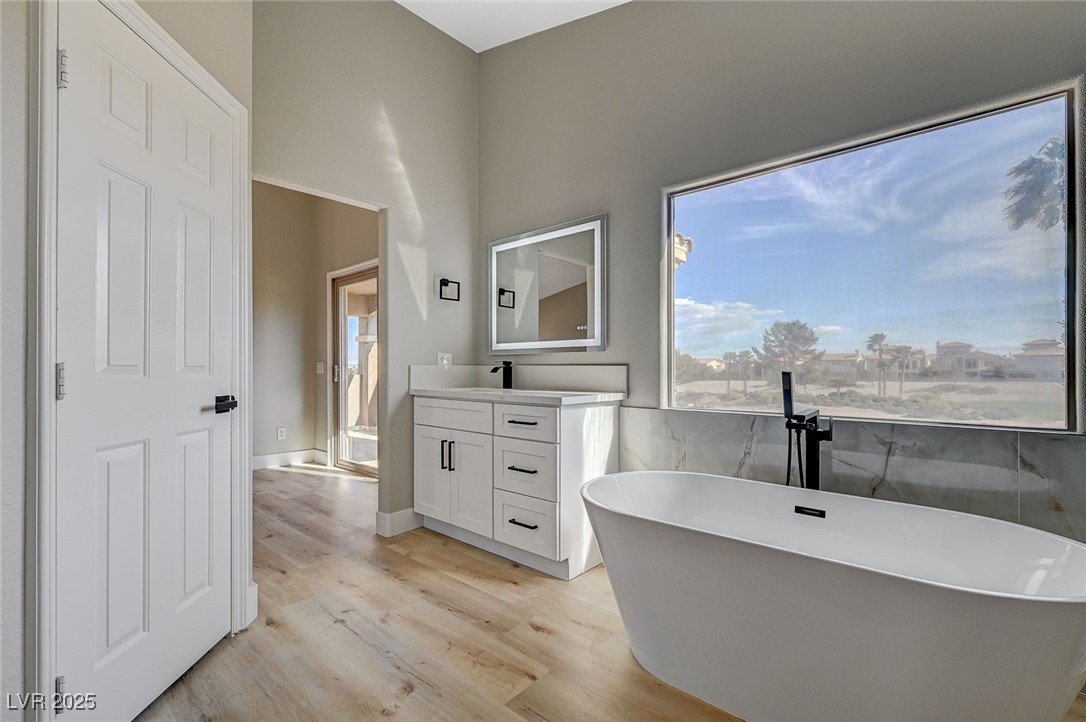 153 Tall Ruff Drive Las Vegas, NV 89148 - Photo 25 of 59 Bathroom with wood finished floors, a freestanding
