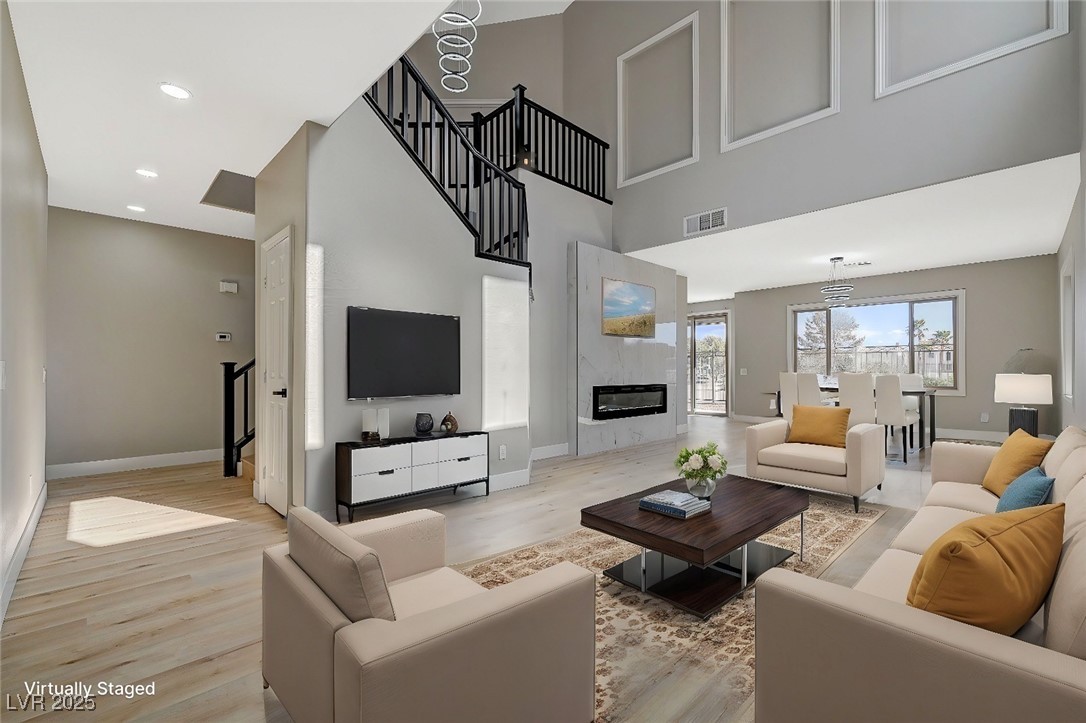 153 Tall Ruff Drive Las Vegas, NV 89148 - Photo 4 of 59 Living room with baseboards, visible vents, and li
