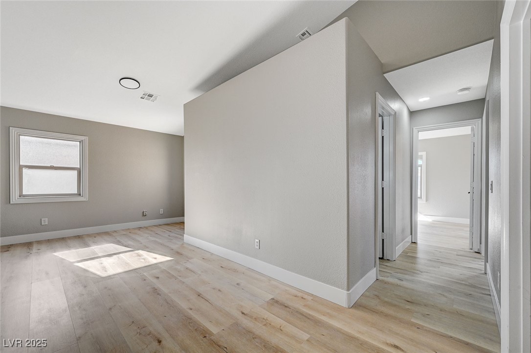 153 Tall Ruff Drive Las Vegas, NV 89148 - Photo 45 of 59 Empty room with baseboards, light wood-style floor
