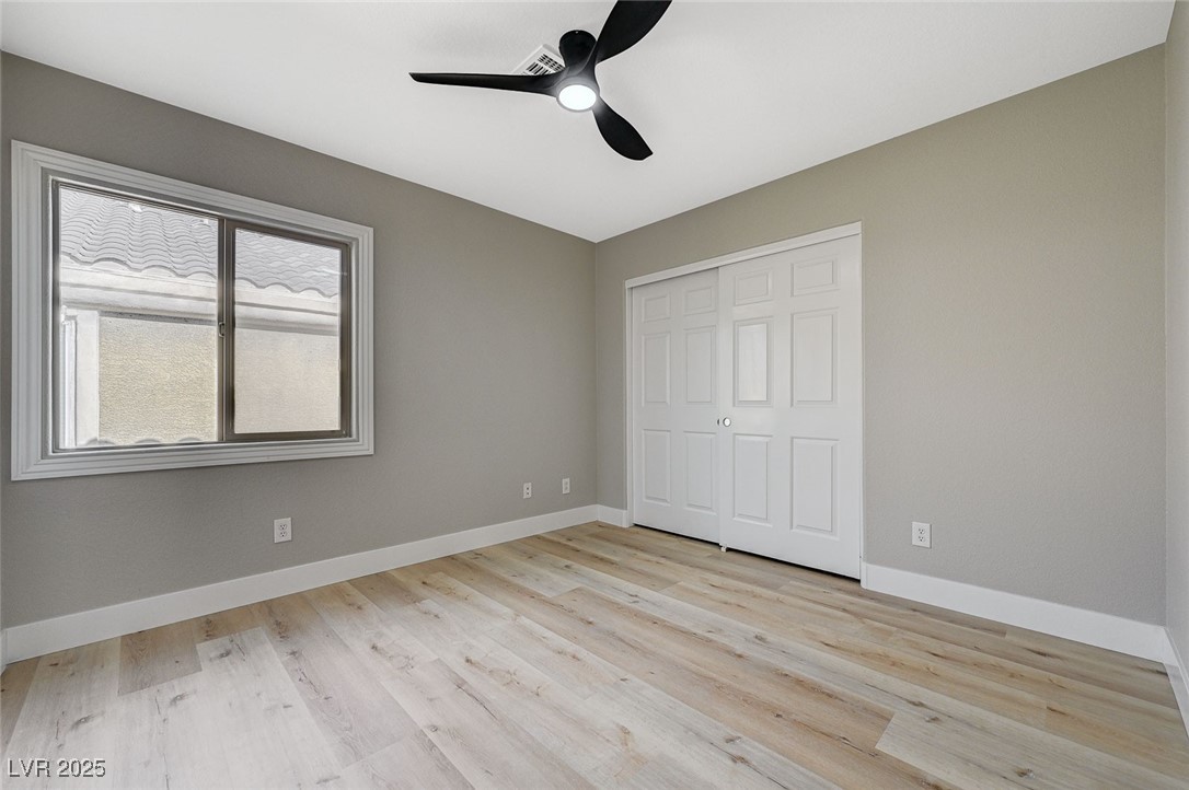 153 Tall Ruff Drive Las Vegas, NV 89148 - Photo 48 of 59 Unfurnished bedroom featuring baseboards, a closet