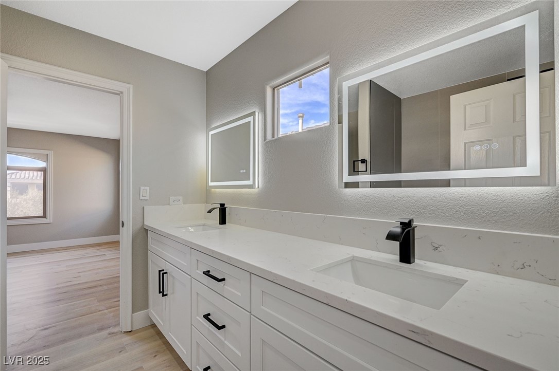 153 Tall Ruff Drive Las Vegas, NV 89148 - Photo 50 of 59 Full bath with baseboards, double vanity, a sink,