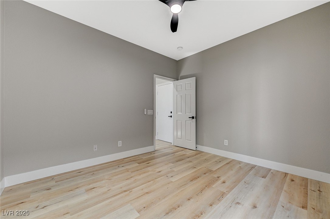 153 Tall Ruff Drive Las Vegas, NV 89148 - Photo 53 of 59 Empty room with baseboards, light wood-style floor