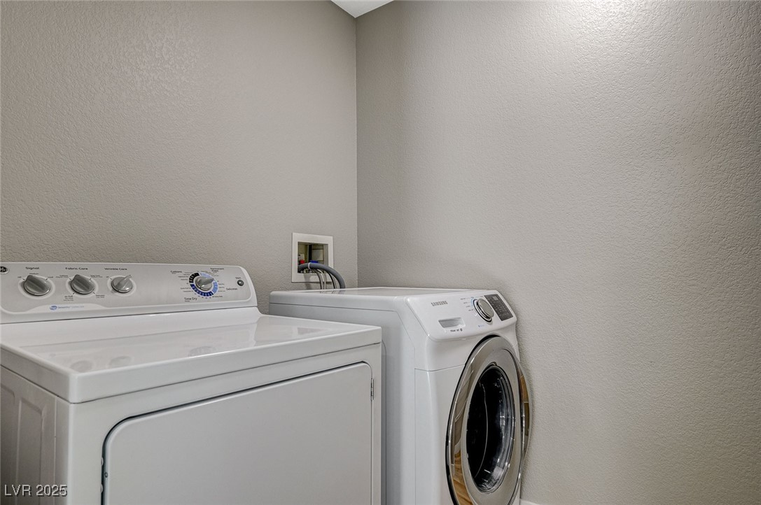 153 Tall Ruff Drive Las Vegas, NV 89148 - Photo 57 of 59 Washroom featuring laundry area, a textured wall,