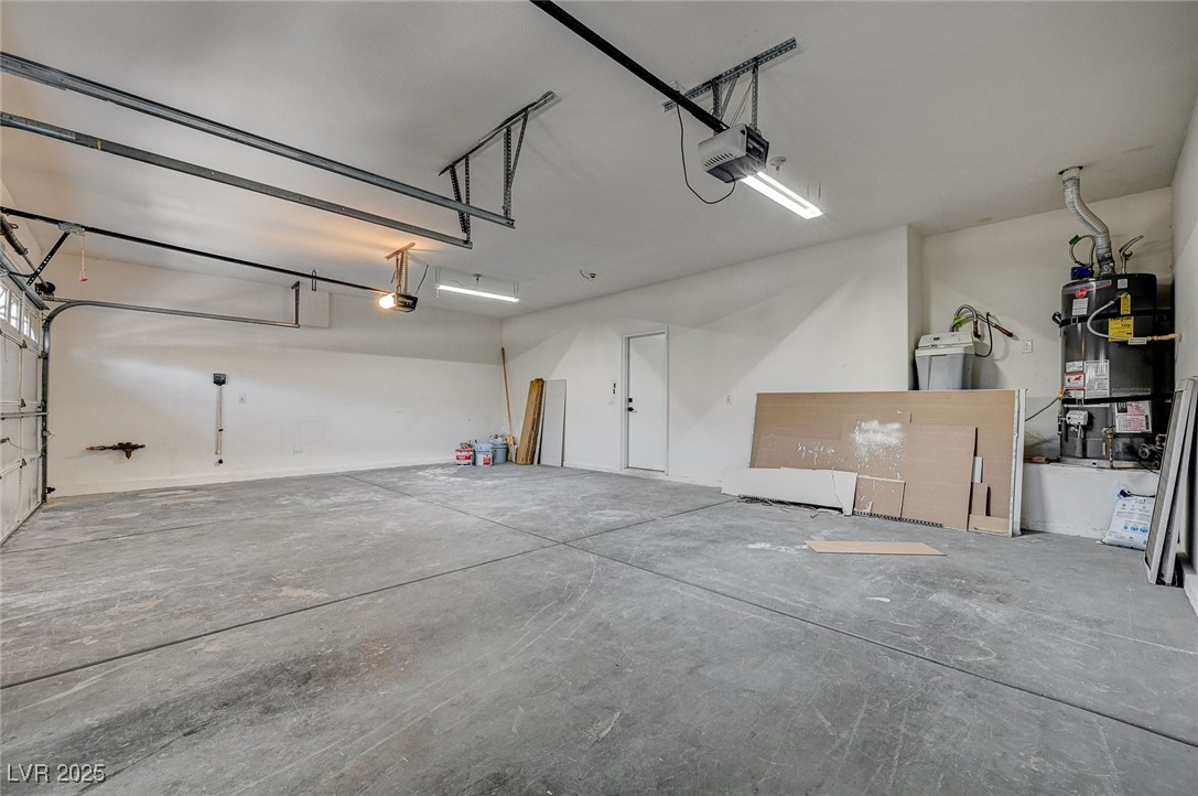 153 Tall Ruff Drive Las Vegas, NV 89148 - Photo 59 of 59 Garage featuring water heater and a garage door op