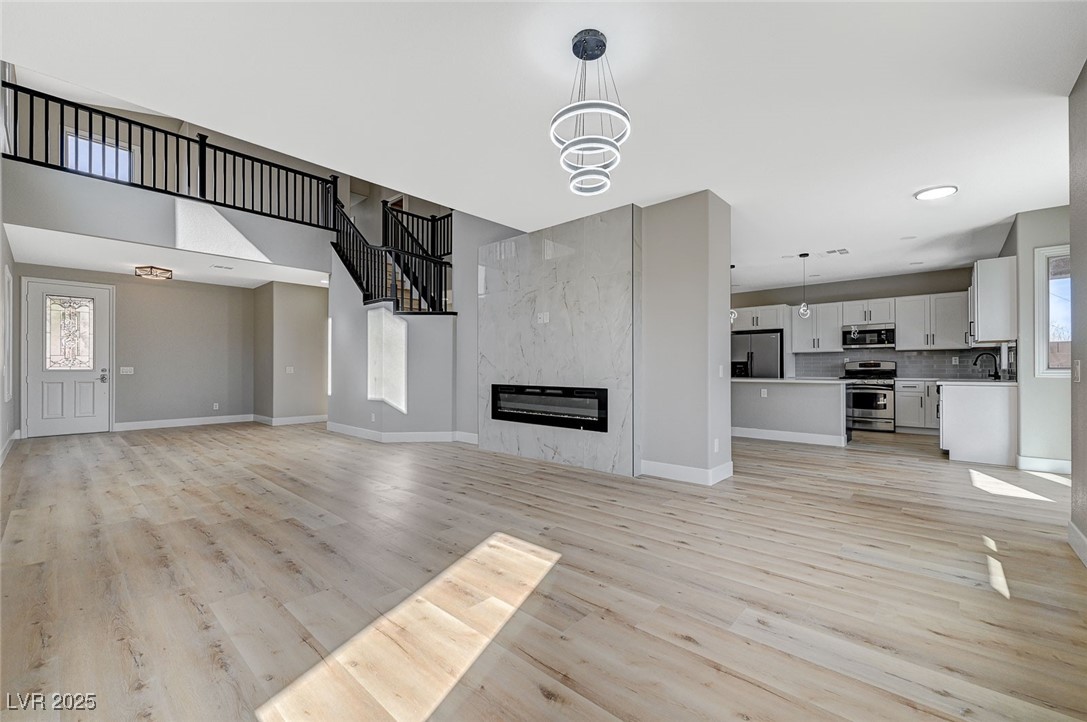153 Tall Ruff Drive Las Vegas, NV 89148 - Photo 9 of 59 Unfurnished living room featuring baseboards, ligh