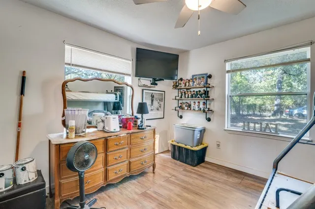 a view of a bedroom with a bed and a large window