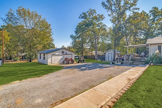 a view of a house with a yard and sitting area