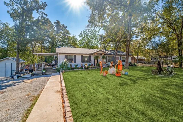 a view of a house with a yard and sitting area