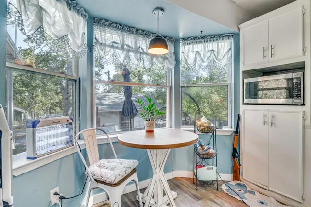 a dining room with furniture a chandelier and wooden floor
