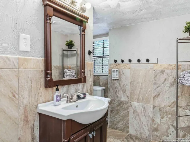 a bathroom with a sink a mirror and a shower