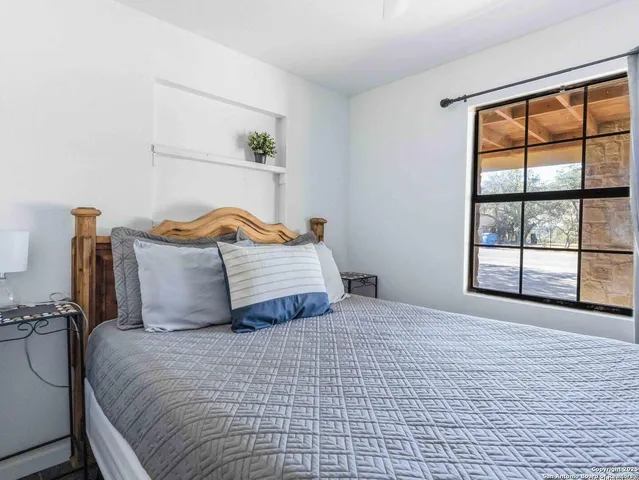 a bedroom with furniture and wooden floor