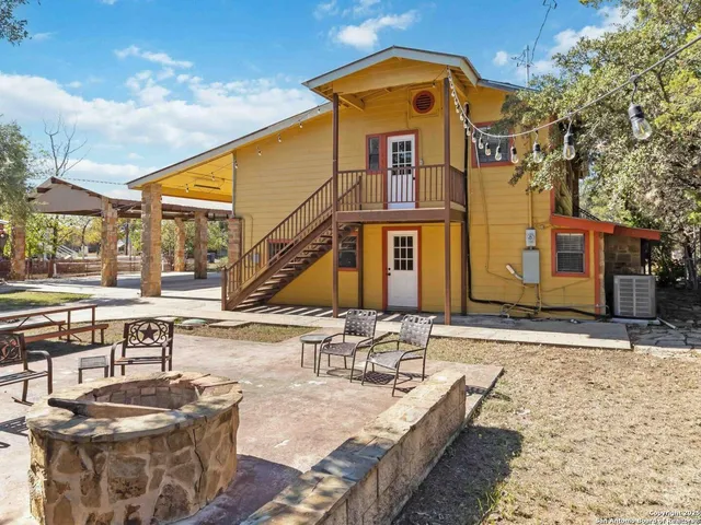 a view of a patio with couches table and chairs with wooden floor
