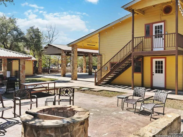 a view of a backyard with swimming pool and furniture