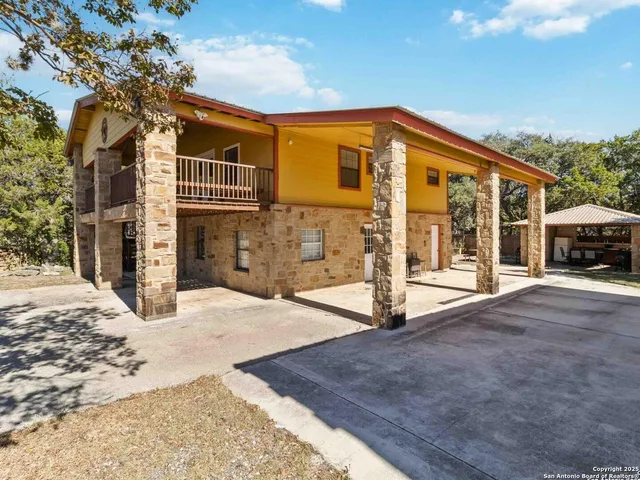 a view of a patio with wooden floor and iron stairs