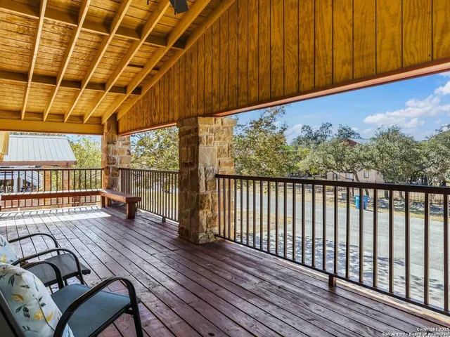 a view of a livingroom with wooden floor and iron stairs