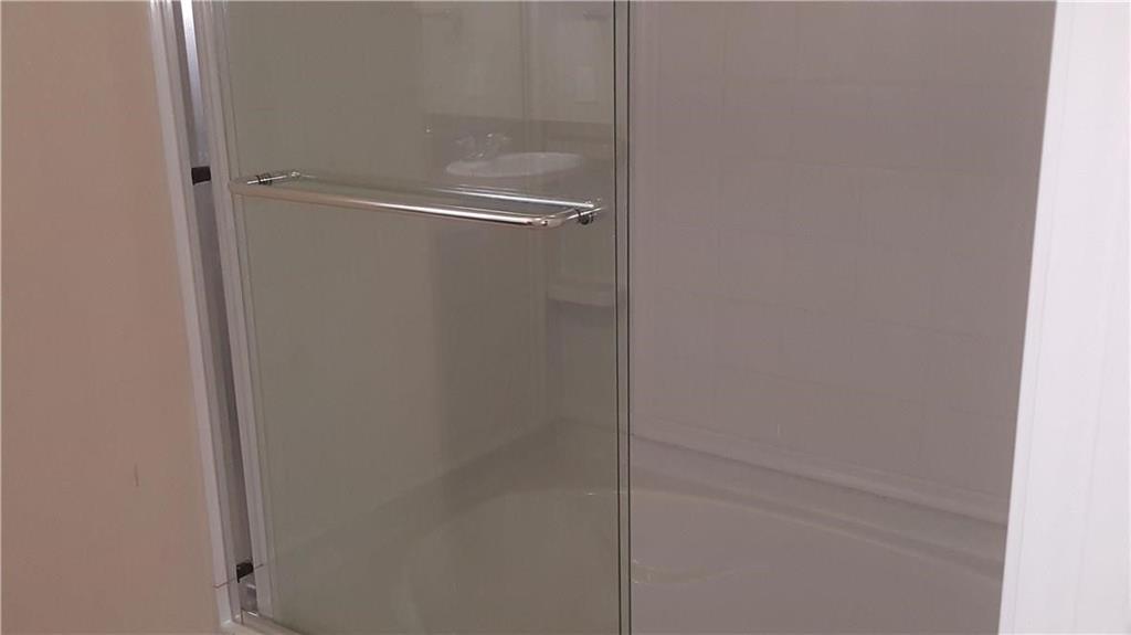 8217 Spotted Doe Drive Fort Worth, TX 76179 - Photo 12 of 22 a bathroom with a glass shower door