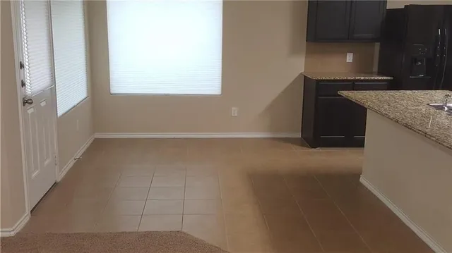 a kitchen with granite countertop a sink a stove and a microwave