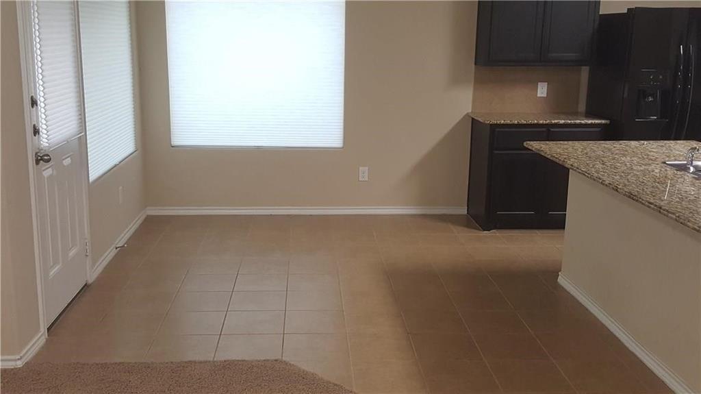 8217 Spotted Doe Drive Fort Worth, TX 76179 - Photo 6 of 22 a view of a kitchen cabinets and a stove top oven