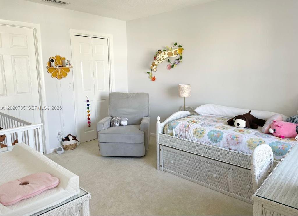 17244 Balboa Point Way Boca Raton, FL 33487 - Photo 33 of 66 a bedroom with a bed and ceiling fan