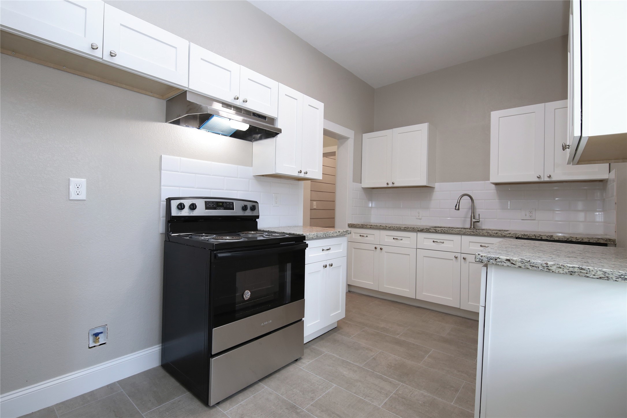 4445 Rusk Street, Unit 2 Houston, TX 77023 - Photo 14 of 21 a kitchen with granite countertop cabinets and steel stainless steel appliances