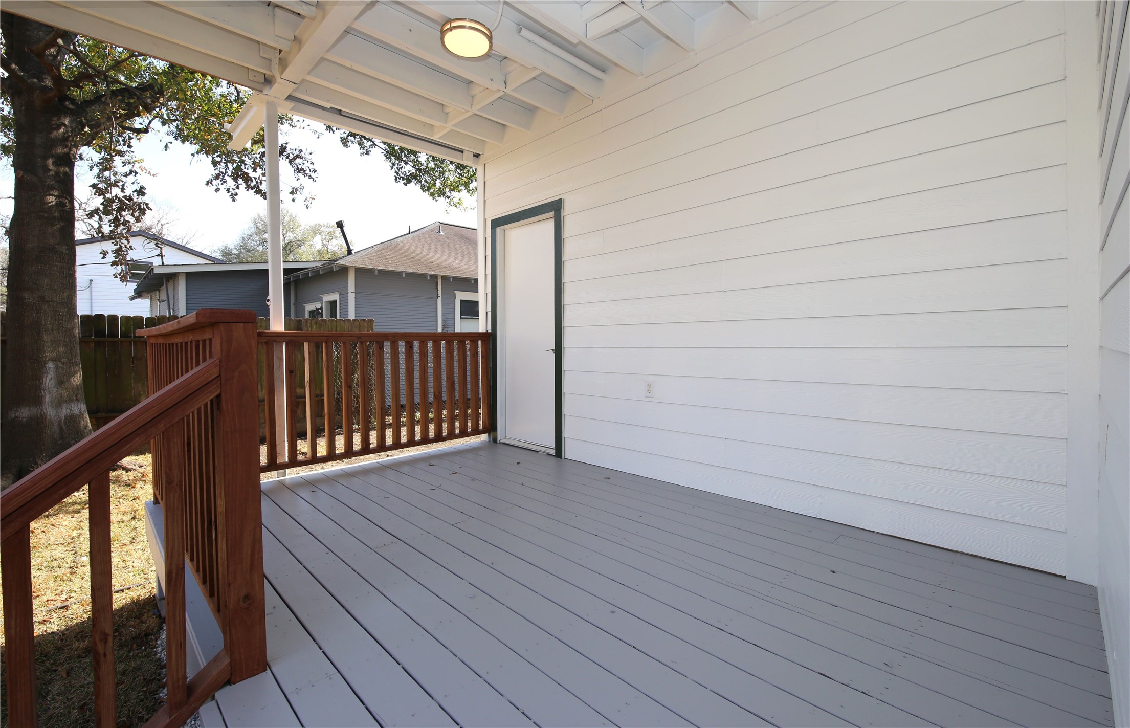 4445 Rusk Street, Unit 2 Houston, TX 77023 - Photo 19 of 21 a view of backyard with a deck and wooden floor