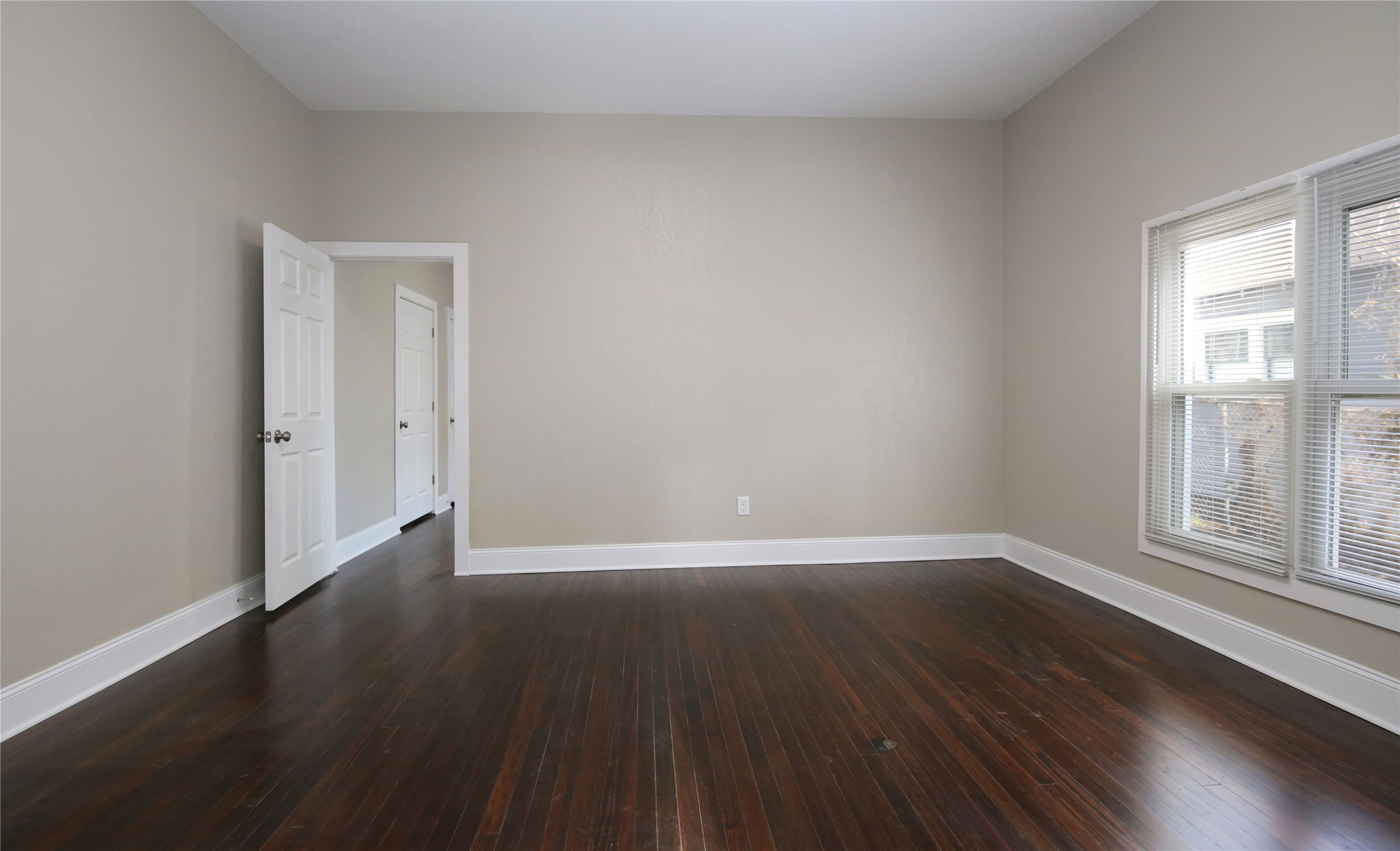 4445 Rusk Street, Unit 2 Houston, TX 77023 - Photo 7 of 21 a view of an empty room with wooden floor and a window