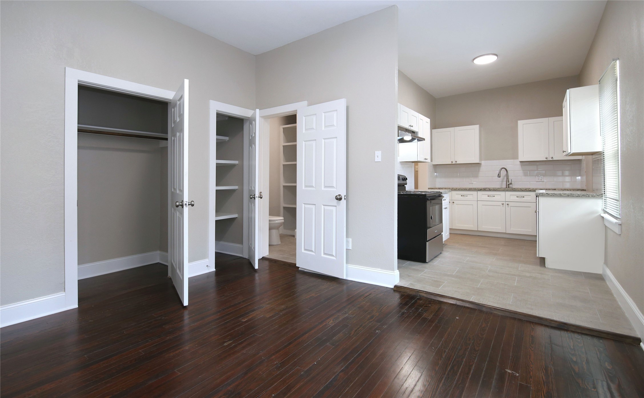4445 Rusk Street, Unit 2 Houston, TX 77023 - Photo 10 of 21 a view of a kitchen with wooden floor and electronic appliances