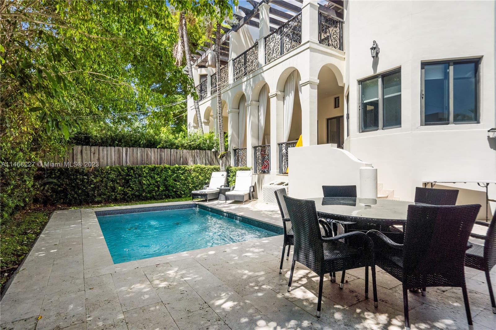 512 Fernwood Road, Unit 2 Key Biscayne, FL 33149 - Photo 11 of 23 a view of a patio with table and chairs and potted plants