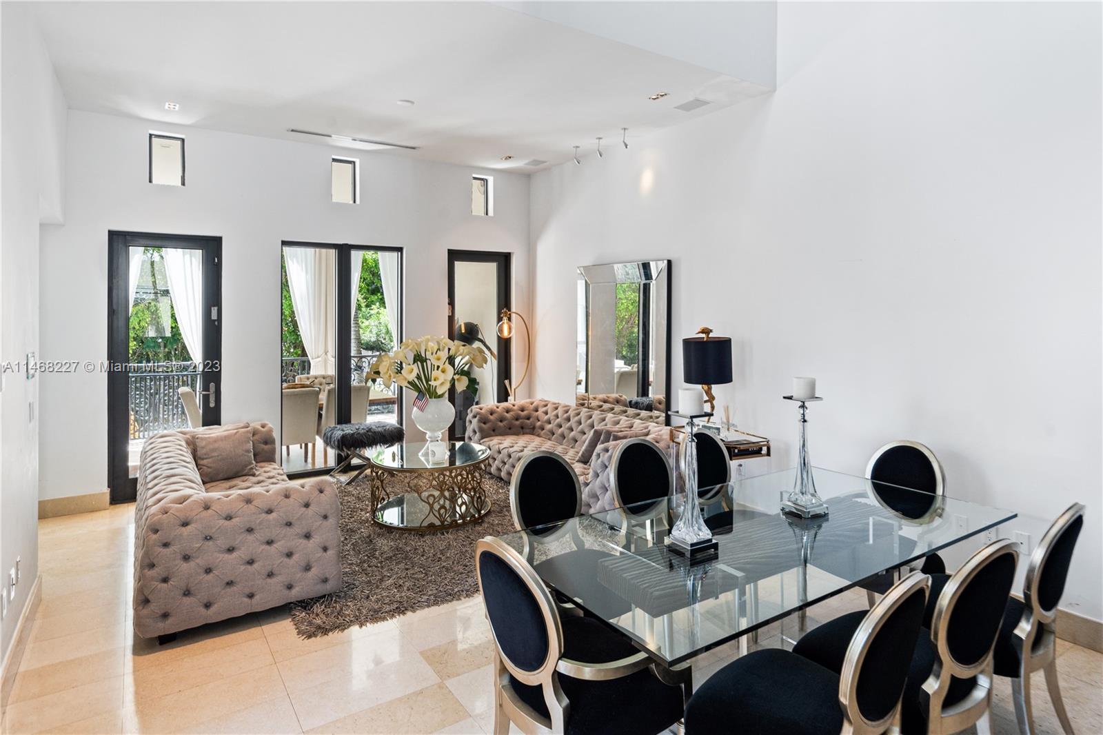 512 Fernwood Road, Unit 2 Key Biscayne, FL 33149 - Photo 2 of 23 a living room with furniture and floor to ceiling windows