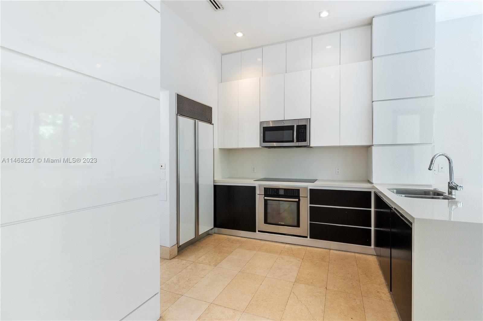 512 Fernwood Road, Unit 2 Key Biscayne, FL 33149 - Photo 21 of 23 a kitchen with stainless steel appliances a refrigerator sink and microwave