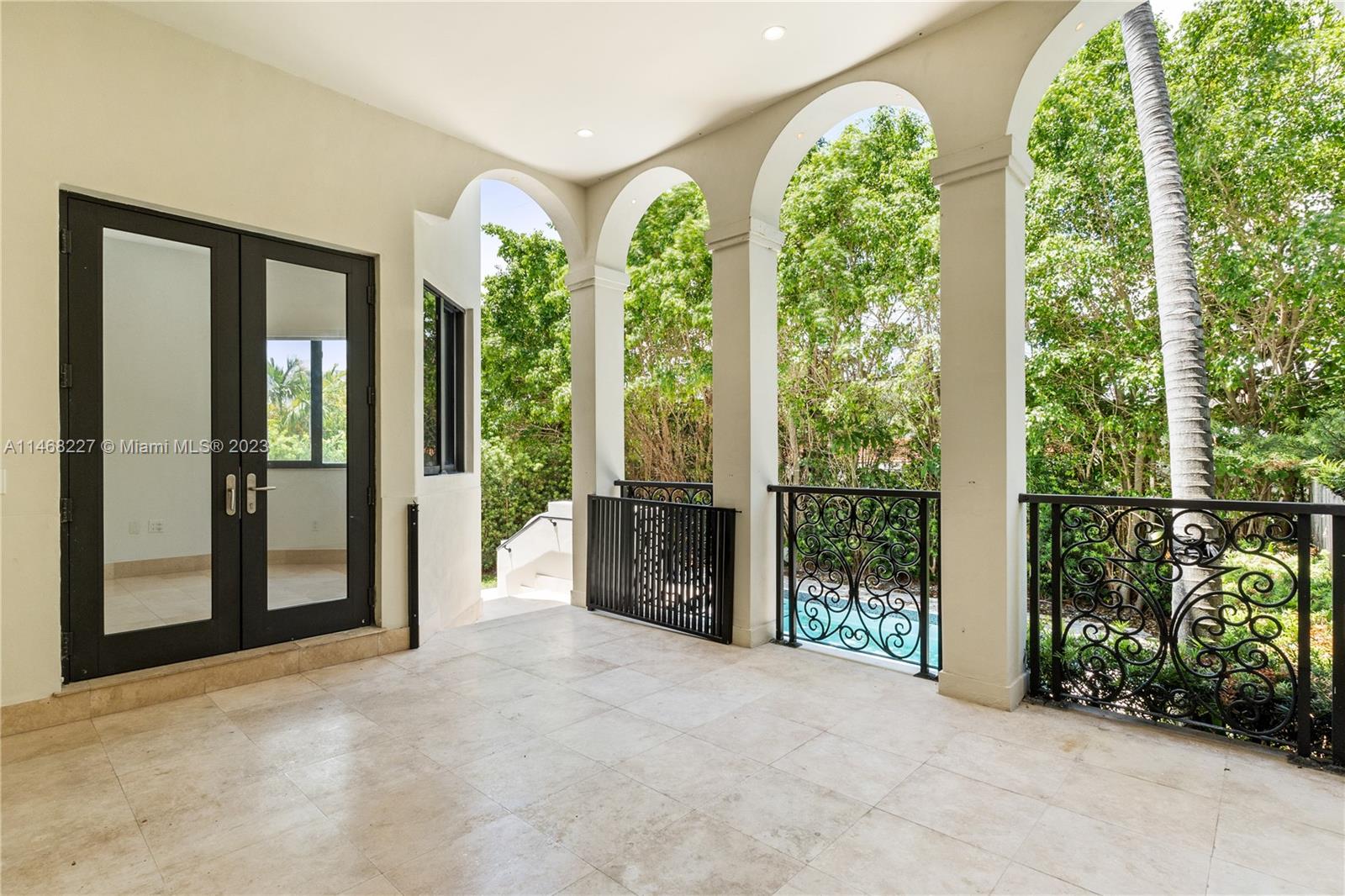 512 Fernwood Road, Unit 2 Key Biscayne, FL 33149 - Photo 22 of 23 a view of a big room with windows and front door
