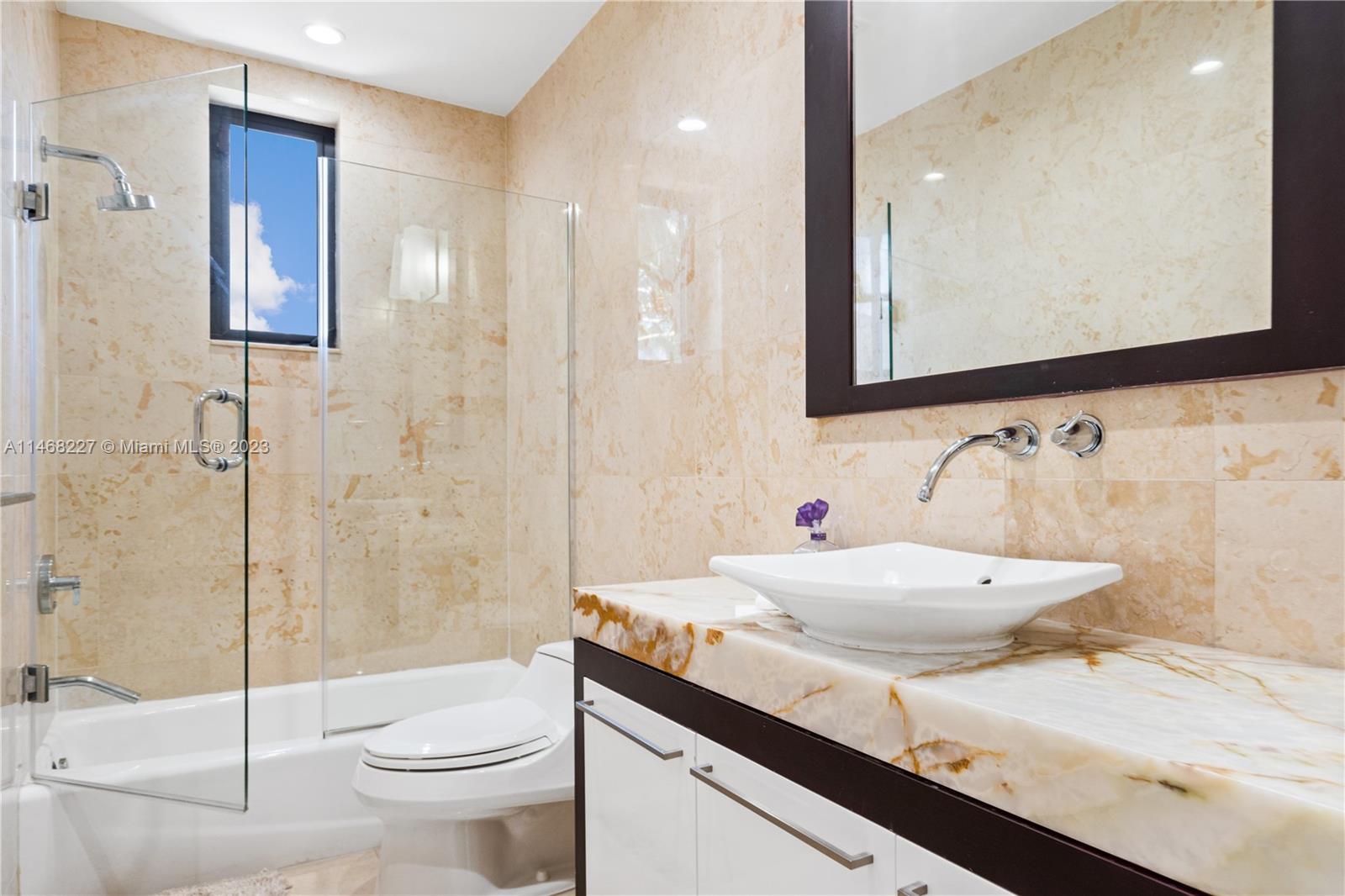 512 Fernwood Road, Unit 2 Key Biscayne, FL 33149 - Photo 5 of 23 a bathroom with a sink a toilet and shower