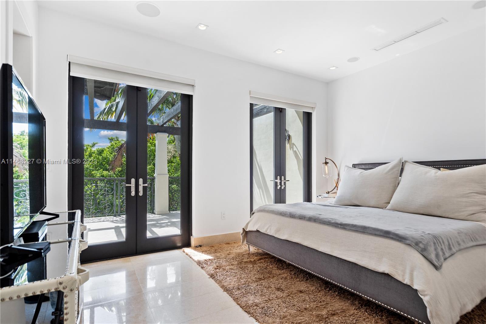 512 Fernwood Road, Unit 2 Key Biscayne, FL 33149 - Photo 6 of 23 a spacious bedroom with a large bed and a large window