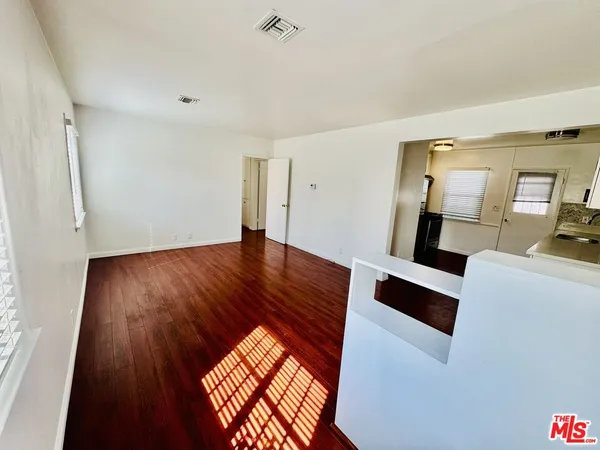 a view of kitchen with wooden floor and electronic appliances