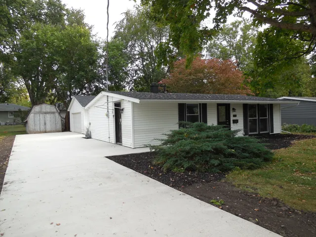a front view of house with yard and trees