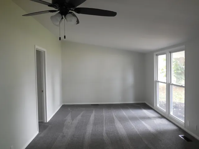 an empty room with a empty space and a window