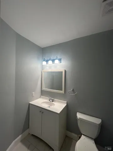a bathroom with a sink mirror and toilet
