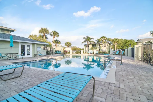 a view of a patio with couches and table and chairs and potted plants