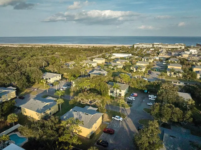 an aerial view of residential building and lake