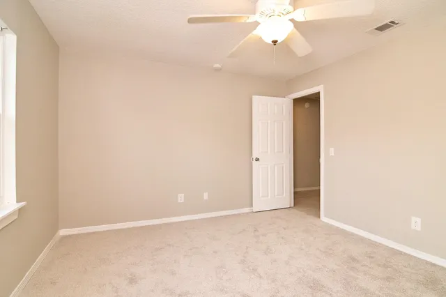 a bathroom with a toilet and shower
