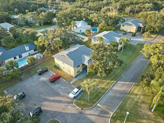 an aerial view of residential houses with outdoor space
